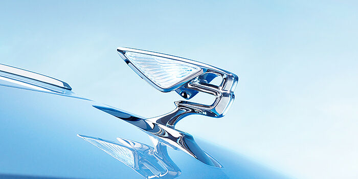 Bentley Cairo Bentley Flying Spur Azure sedan bonnet close up in Light Windsor Blue paint with Illuminated Flying B mascot