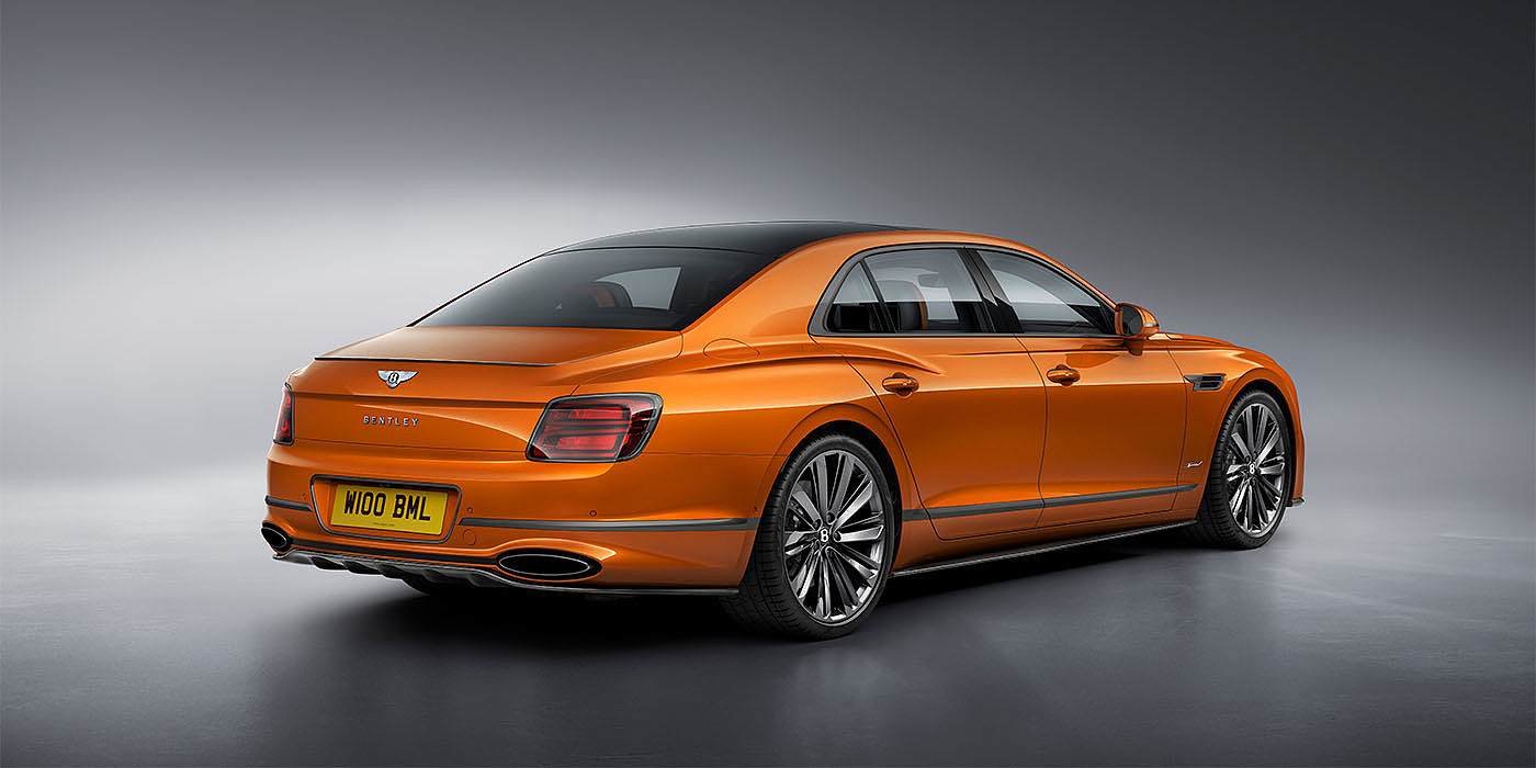 Bentley Cairo Bentley Flying Spur Speed in Orange Flame colour rear view, featuring Bentley insignia and enhanced exhaust muffler.