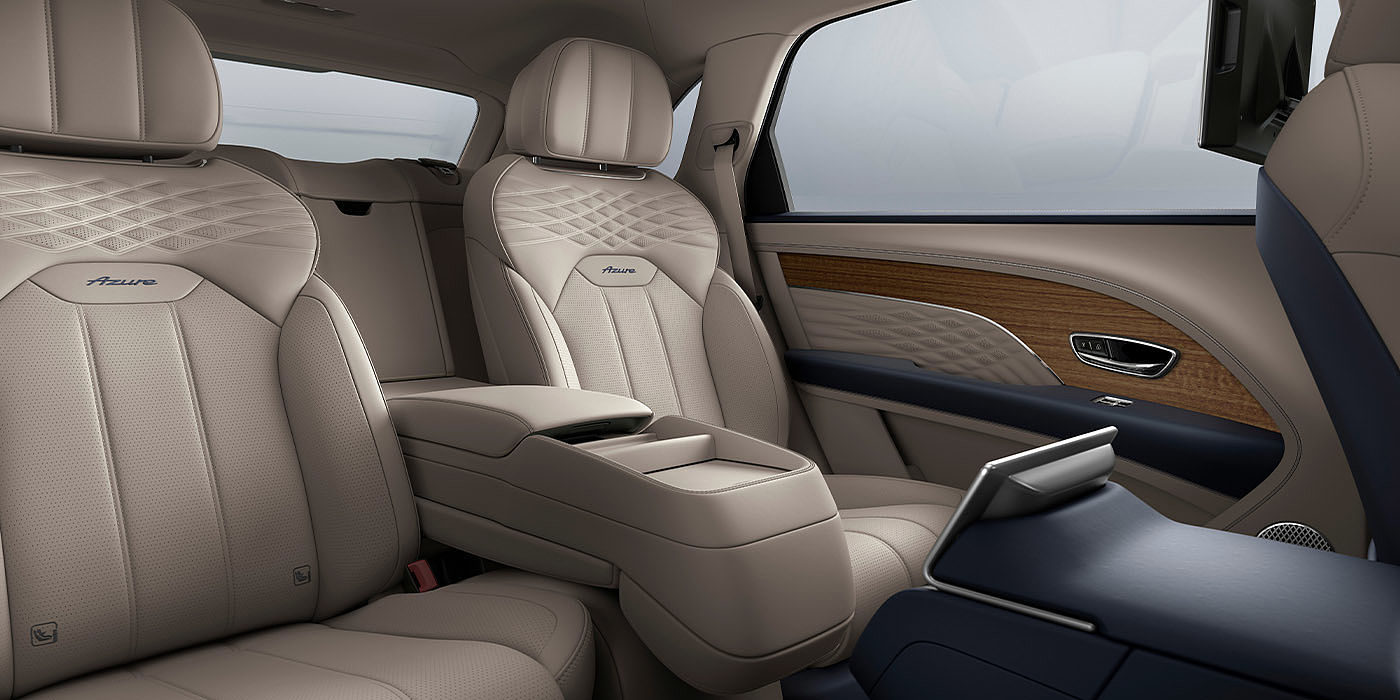 Bentley Cairo Bentley Bentayga EWB Azure interior view for rear passengers with Portland hide featuring Azure Emblem in Imperial Blue contrast stitch.