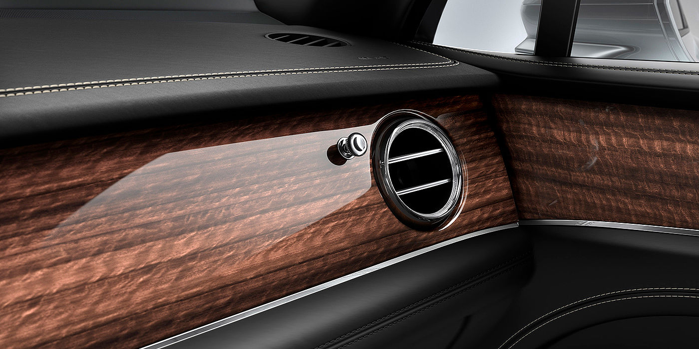 Bentley Cairo Bentley Bentayga front interior Crown Cut Walnut veneer and chrome air vent.