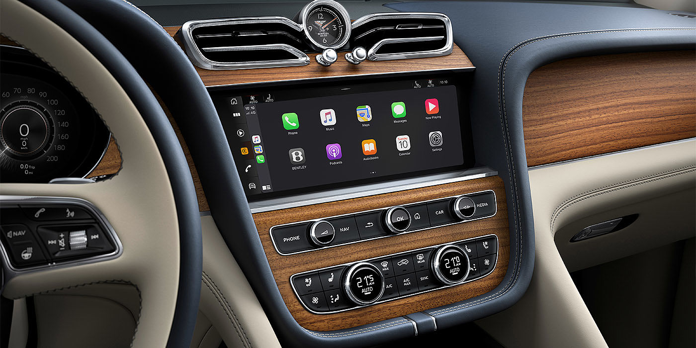 Bentley Cairo Bentley Bentayga EWB Azure dashboard in Open Pore Koa veneer featuring multimedia screen and climate control console.