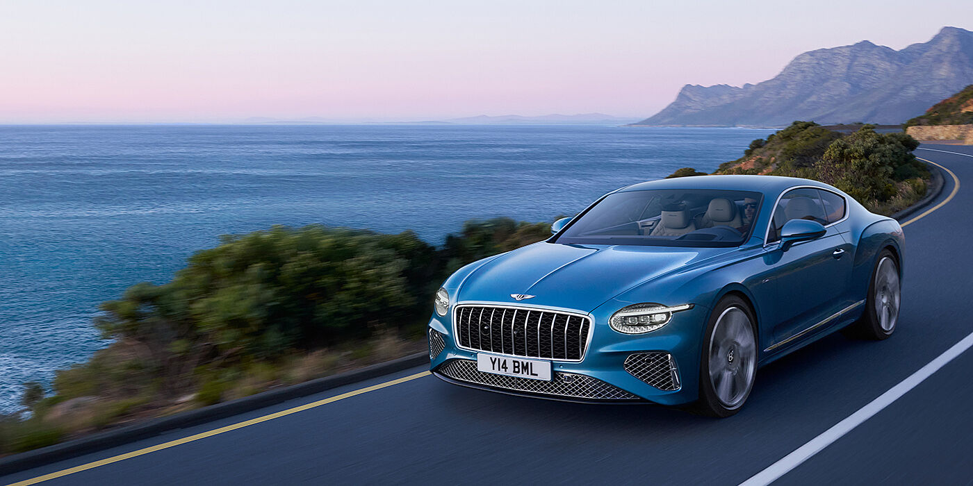 Bentley Cairo New Bentley Continental GT Azure coupe in Light Windsor blue paint with 22 inch Azure wheels and chrome grill, driving dynamically by the se