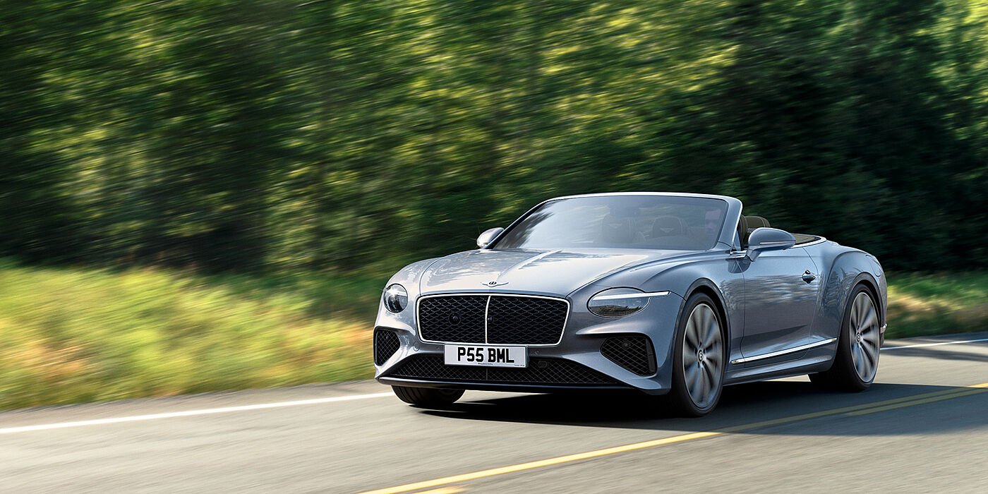 Bentley Cairo New Bentley Continental GTC convertible front view in Silverlake paint with 22 inch ten spoke wheels, driving dynamically on a country road
