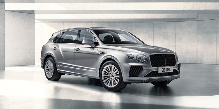 Bentley Cairo Bentley Bentayga Extended Wheelbase SUV front three quarter in Moonbeam paint with a grey background